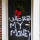 Graffiti reading, “Where’s my money” is seen on a door of the home of Senate Majority Leader Mitch McConnell, R-Ky., in Louisville, Ky., on Saturday, Jan. 2, 2021.